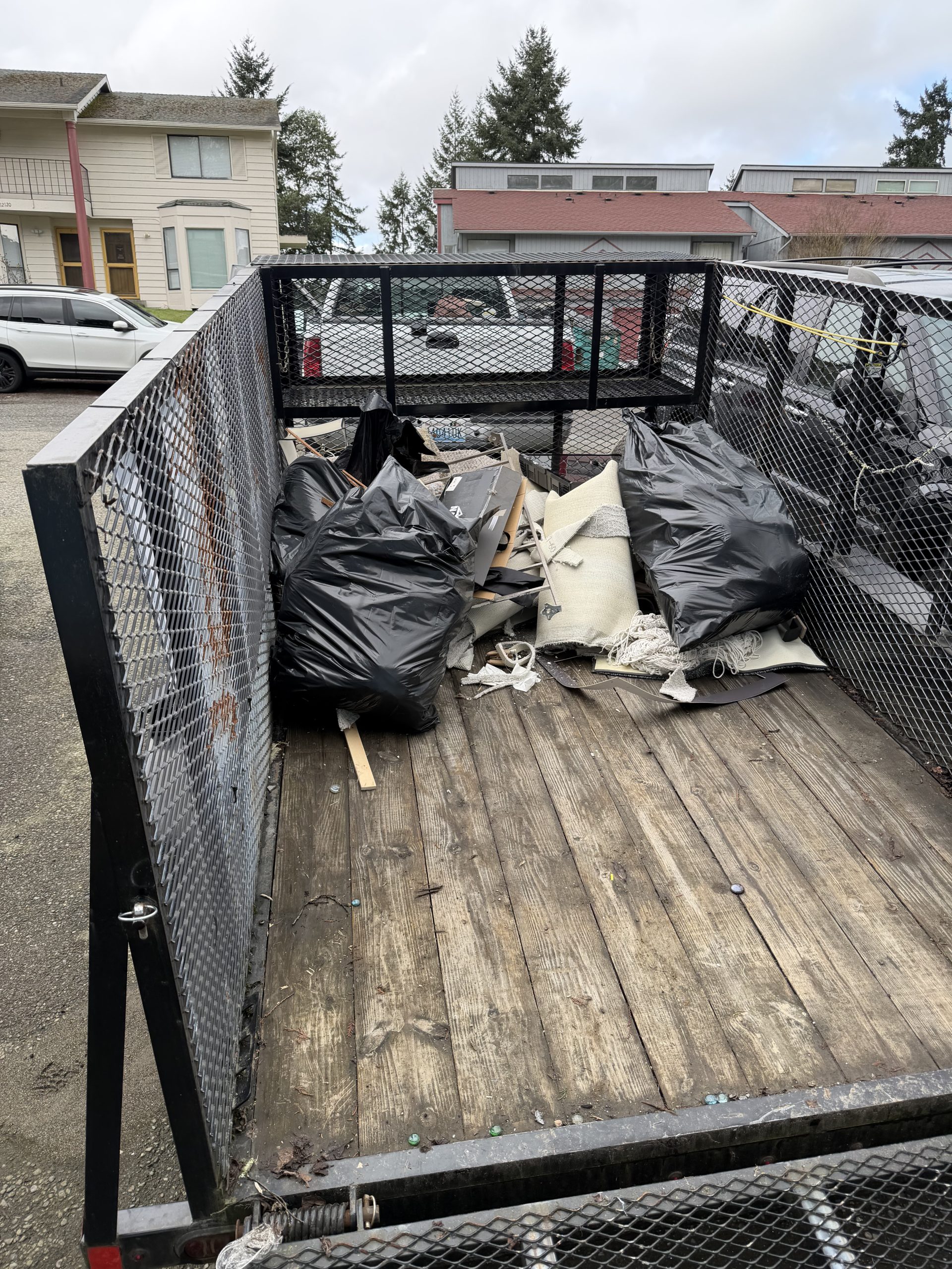 garage cleanout Tacoma trailer partially loaded with junk